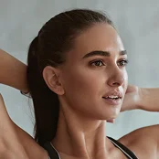 A close-up profile view of a woman with dark hair pulled back into a high ponytail. She is looking slightly upward and to the side with a soft, relaxed expression. - Procedure in San Francisco, CA