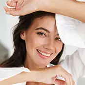 A smiling woman with bright, clear eyes, showcasing smooth skin around the upper and lower eyelids without visible puffiness or sagging. - Upper lower eyelid in San Francisco, CA